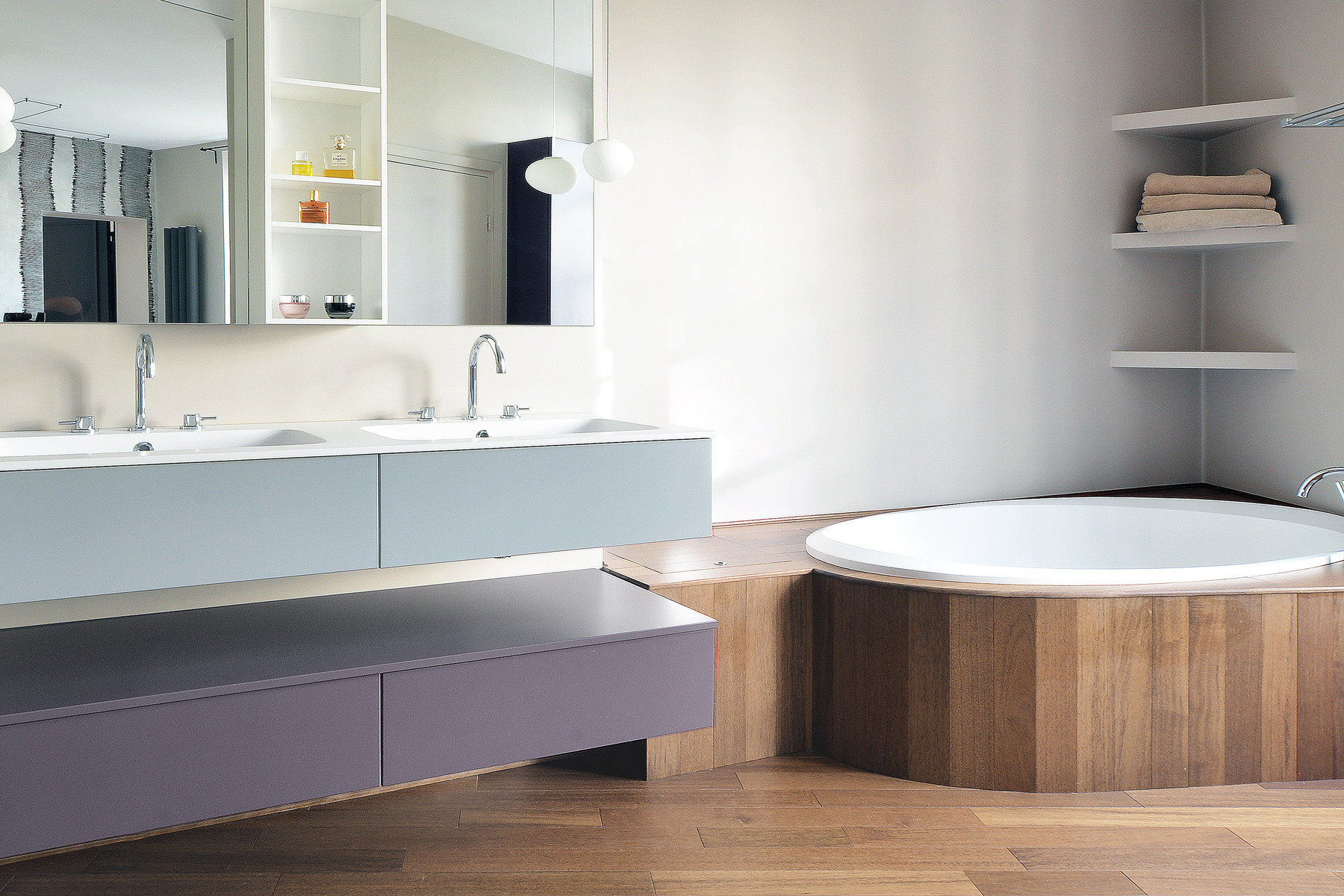 Chambre ouverte sur salle de bain avec baignoire ovale habillée bois et radiateur design — suite parentale Paris 6e